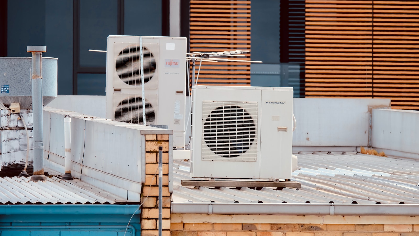 white and gray box fan on brown wooden table